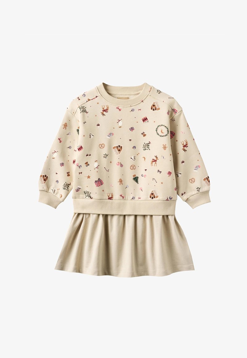 Robe longue à manches longues beige avec des motifs sur le thème de Noël, comprenant des rennes, des maisons en pain d'épice, des cannes de bonbon, des couronnes et des cadeaux, avec une jupe plissée.