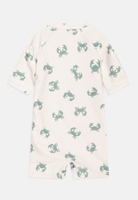 Short-sleeve, cream rash guard featuring a repeated crab pattern in pale green. Made from stretchy fabric, ideal for water activities.
