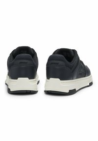 Black leather sneakers with mesh accents, rubber soles, and a chunky white midsole. Features perforations for breathability and logo detail.