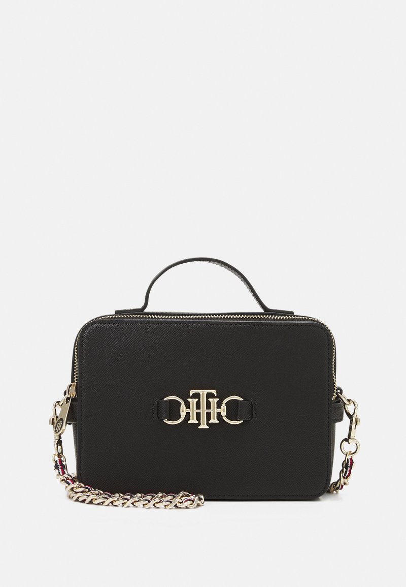 Sac à main rectangulaire noir avec logo doré, poignée supérieure et bandoulière chaîne dorée amovible avec des accents tissés roses et noirs.