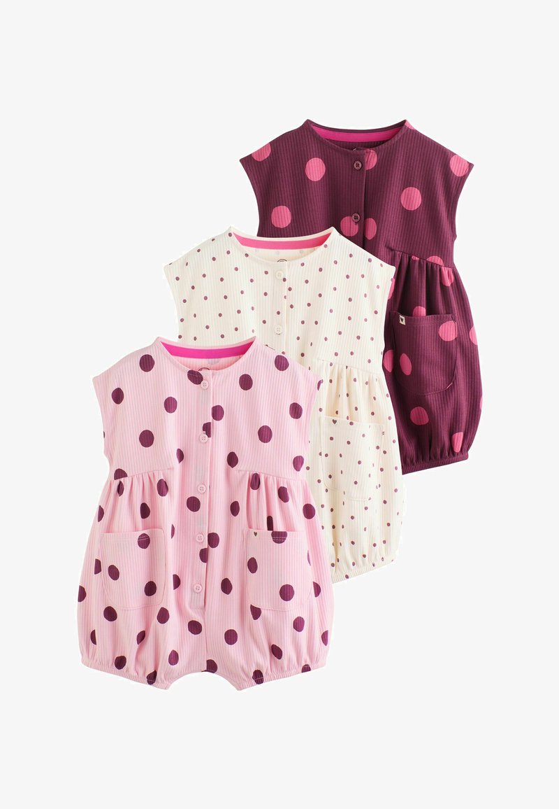 Trois barboteuses sans manches pour bébé avec boutons sur le devant, poches, et ouvertures élastiques pour les jambes ; les couleurs incluent rose, crème et bordeaux avec des pois.