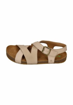 Beige leather sandal with crossed straps, adjustable metal buckle, open toe, and flat cushioned sole.