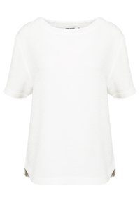 Vit kortärmad topp med en texturerad, något upphöjd tyg. Rund halsringning och avslappnad passform, med opak material och sido slitsar.