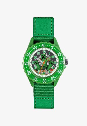 Orologio da polso verde con cinturino in nylon testurizzato. Il fondello rotondo presenta un grafico di personaggi pixelati su uno sfondo scuro. Numeri in bianco e verde.