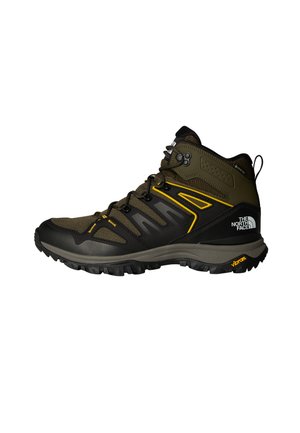 Mid-cut hiking boots in olive green with black accents, featuring a mesh upper, Vibram sole, and prominent lacing system. Yellow design details.
