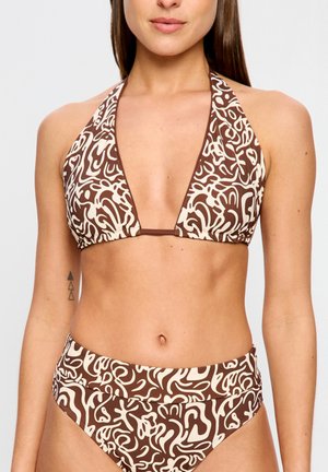 Woman wearing a brown and cream abstract patterned halter bikini with high-waisted bottoms, showing torso and arms with a small geometric tattoo.