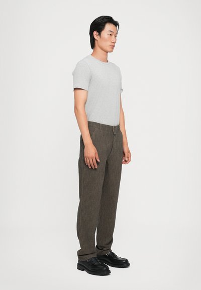 Grey short-sleeve t-shirt paired with brown pinstriped trousers and black shoes, featuring a straight leg design and textured fabric.
