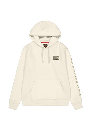 Cremfarbener Kapuzenpullover mit einer Fronttasche, Kordelzügen und einem Patch mit Grafik. Textdesign auf dem linken Ärmel.