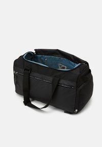 Black duffel bag with a zippered top, adjustable straps, and a blue interior featuring a logo pattern. Durable fabric and sleek design.
