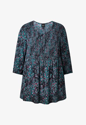 Kukallinen tunika, jossa on V-kaula-aukko ja nauhakiinnitys. Värimaailma sisältää teallia, burgundia ja mustaa. Valmistettu kevyestä kankaasta ja väljällä mitoituksella.