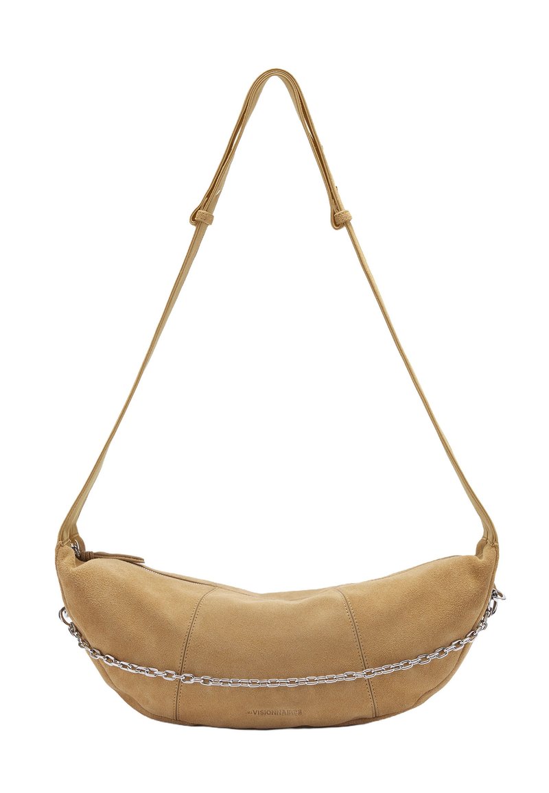 Tan suede shoulder bag with curved shape, a single long strap, and a silver chain accent across the front. Zipper closure on the side.