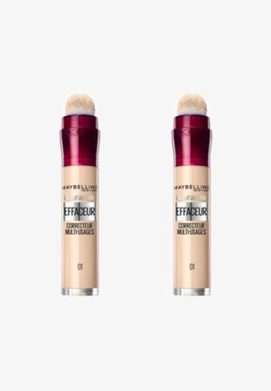 Anticernes Maybelline Instant Anti-Age, deux tubes avec un embout applicateur doux, capsules transparentes bourgogne, produit de couleur beige, étiqueté "01".