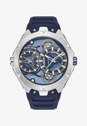 Zegarek na gumowym pasku w kolorze granatowym z srebrową ośmiokątną kopertą, dwiema strefami czasowymi, niebieską tarczą, motywami zębatkami oraz wyraźnymi godzinowymi wskaźnikami.