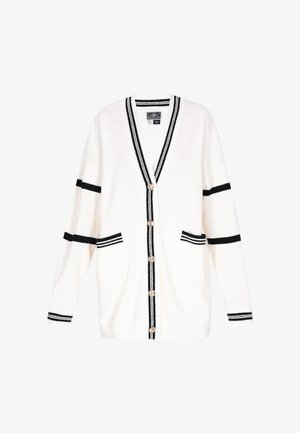 White cardigan with black stripes on sleeves, cuffs, front edges, two front pockets, and five buttons down the center.