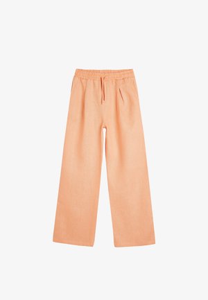 Licht perzik brede broek met een elastische tailleband, trekkoord en twee voorkruiken. Gemaakt van een zachte, gestructureerde stof.