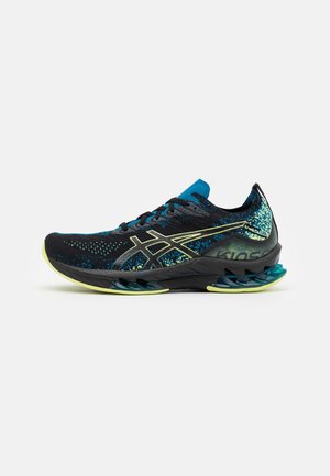 Black and blue athletic shoes with a textured upper, featuring a distinctive wave sole, metallic accents, and a cushioned collar.