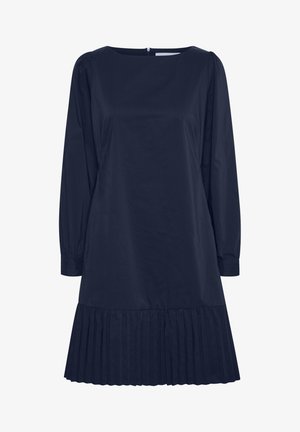 Mörkblå skjortklänning i glatt tyg, med långa puffärmar och plisserad fåll. Enkel rund halsringning och dragkedjedetalj i ryggen.