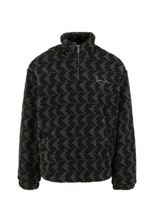 Suéter peludo en verde oscuro y negro con un patrón de zigzag, cuello con media cremallera y logo bordado en el pecho. Material de forro polar texturizado.