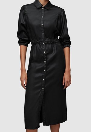 Schwarzes Midi-Kleid aus Kunstleder mit langen Puffärmeln, Druckknopfverschluss vorne, elastischer Taille und Kragen.