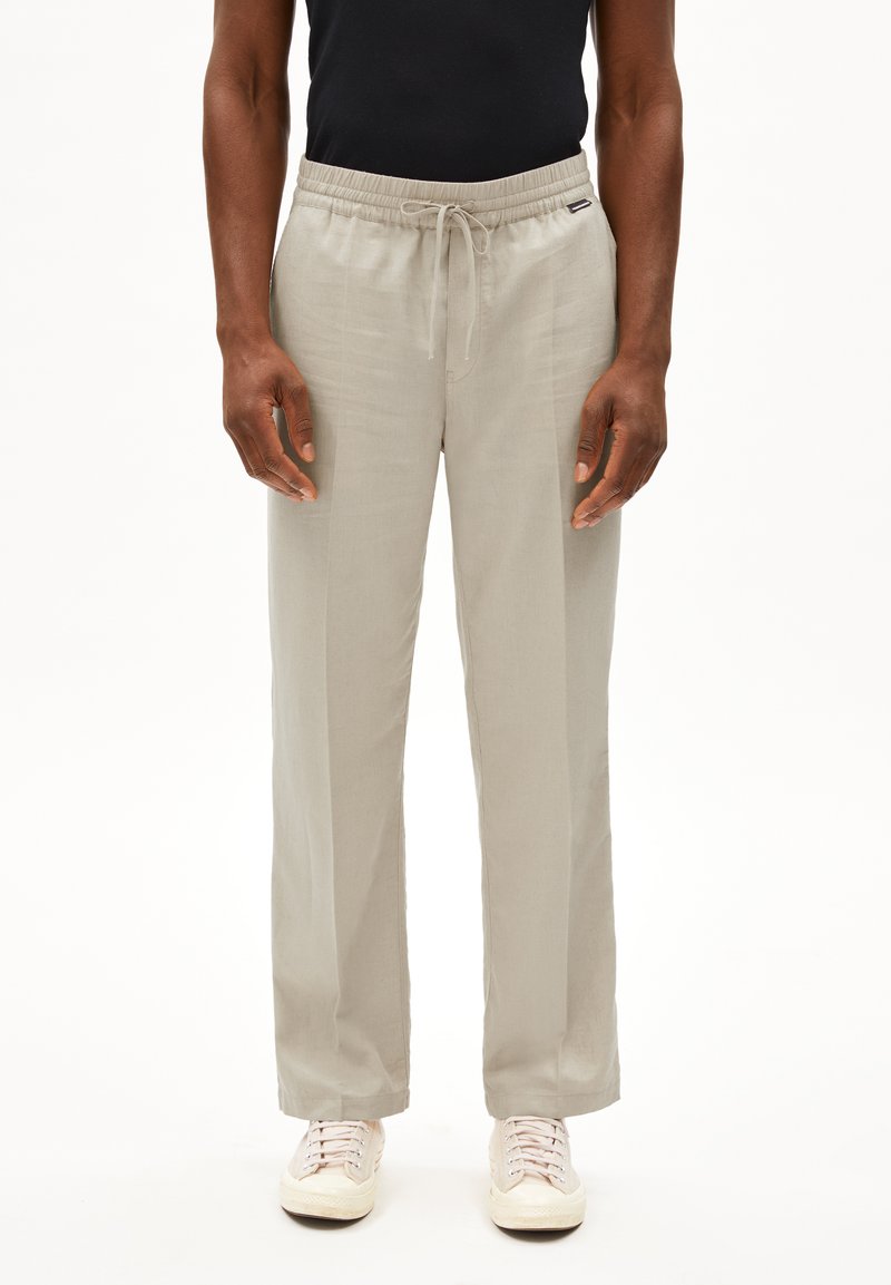 Lichtgrijze, wijd gesneden broek met een elastische tailleband en strikkoord. Gemaakt van zachte stof, met een ontspannen ontwerp voor comfort.