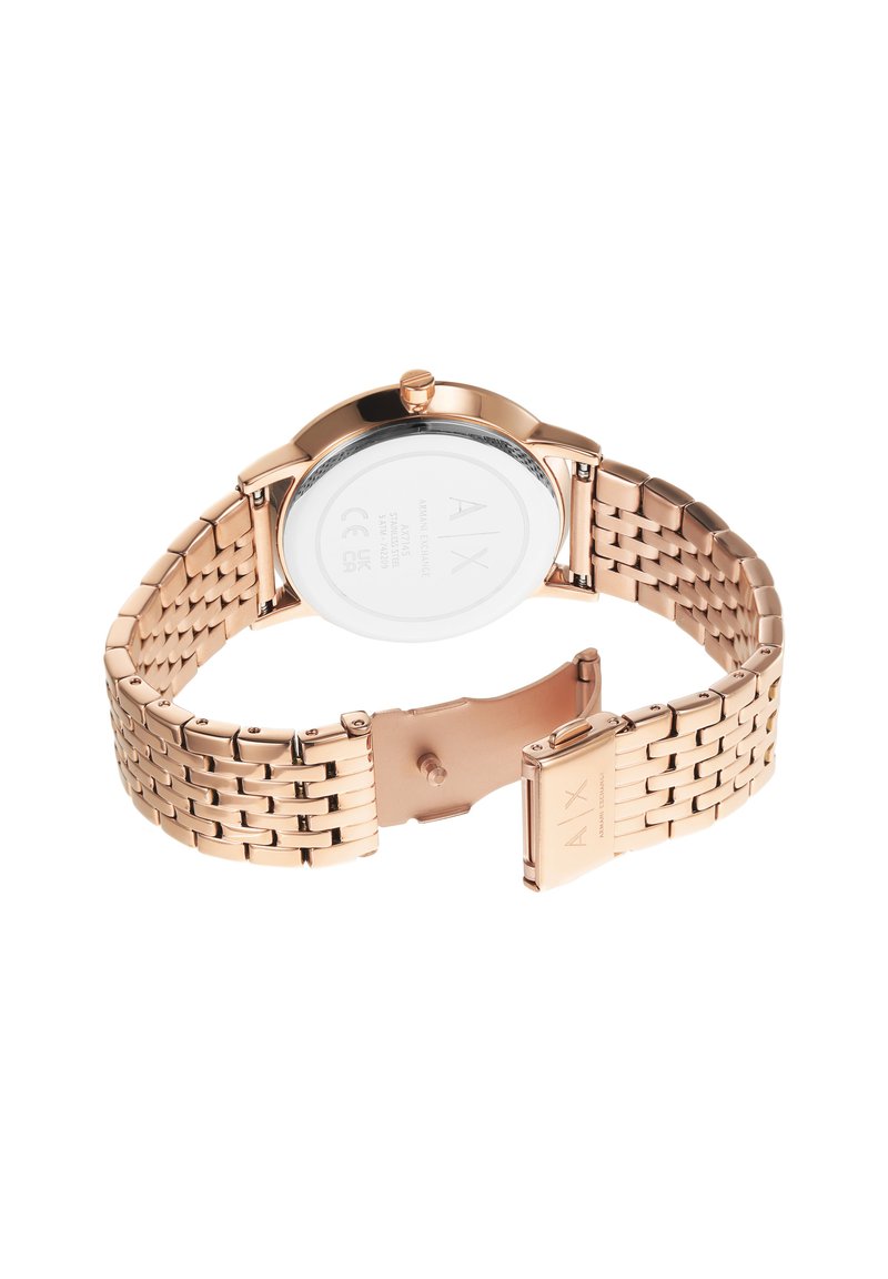 Rose gold metal watch with a stainless steel bracelet, round case, glass back, and clasp closure; features brand initials on the case.