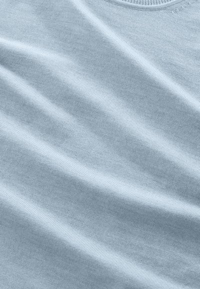 Light blue cotton fabric with a smooth texture, featuring subtle waves and a ribbed neckline, showcasing a soft, even finish.