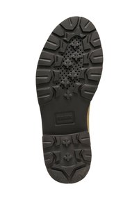 Suela de zapato de goma negra con un patrón texturizado que presenta surcos profundos y agujeros de ventilación, marcada con "GEOX" para permitir la transpiración.