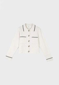 Gilet en tricot blanc avec col, finition noir festonnée et deux poches avant. Equipé de grands boutons sur le devant et de manches longues.