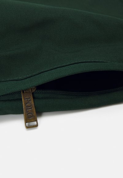 Dark green fabric bag with a zipper featuring a bronze pull tab marked "POLO." The texture is smooth with a clean finish.