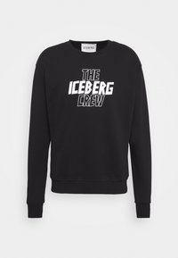 Felpa nera col collo rotondo in cotone, con la scritta bianca in grassetto "THE ICEBERG CREW" sul davanti. Polsini e orlo a costine.