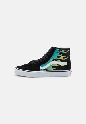 High-top black suede sneakers with colorful flame graphics in green and yellow, white stripe detailing, and white rubber sole.
