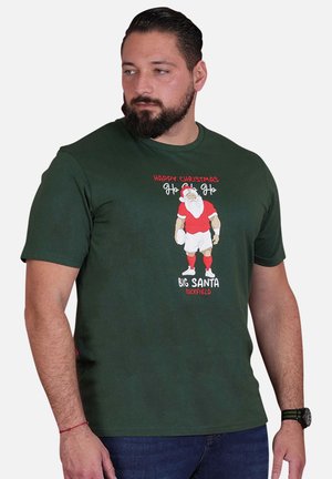 T-shirt en coton vert foncé avec un motif imprimé de Santa en tenue de rugby, surmonté du texte "Joyeux Noël Ho Ho Ho".