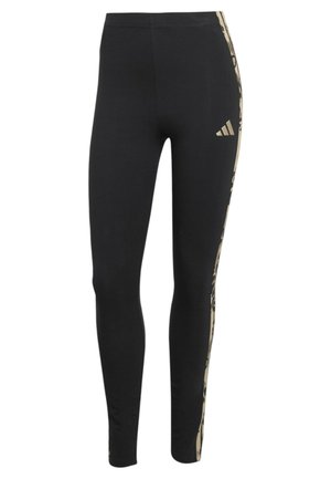 Leggings aderenti neri con strisce laterali beige a motivo e piccolo logo Adidas beige sulla parte superiore della coscia.