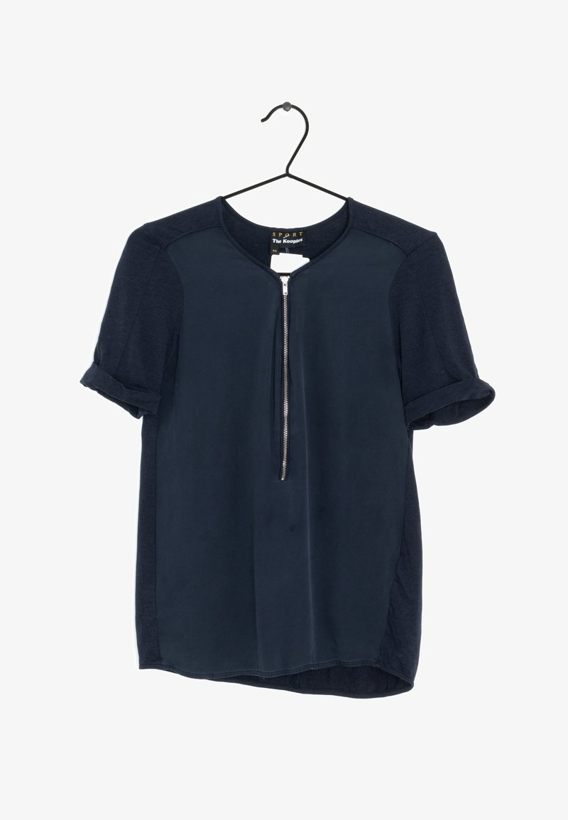 Navy short-sleeve blouse with a round neckline and a front zipper detail. Made from a smooth fabric with rolled sleeve cuffs.