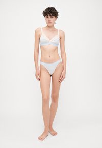 Light blue and white striped bra and matching thong, featuring a lace trim and soft elastic bands for comfort. Smooth texture, triangular design.