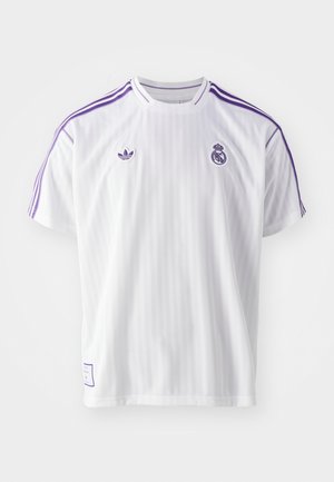 White athletic shirt with purple stripes, featuring a round crew neck, short sleeves, and embroidered logos on the chest. Vertical pinstripes pattern.