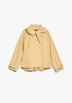 Veste jaune clair avec un grand col en nœud, manches longues et ourlets à revers. Fabriquée en tissu lisse avec une coupe structurée et des détails minimalistes.