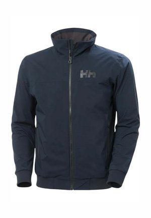 Chaqueta azul marino con cremallera frontal y cuello alto, fabricada en material sintético, con puños elásticos y un sutil logo en el pecho. Textura suave, diseño ajustado.