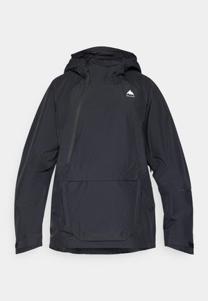 Svart vanntett jakke med hette, halv glidelås foran og frontlomme. Har logo på brystet og justerbare mansjetter. Glatt tekstur.