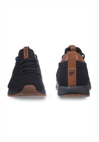 Black knit sneakers with a textured finish, brown leather accents on the heel and tongue, featuring a low-profile sole and laces.