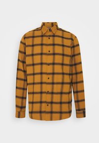 Chemise à carreaux jaune moutarde et noir, manches longues, fermeture boutonnée à l'avant, col, tissu doux, dotée d'un motif tartan classique.
