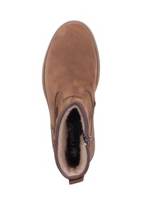 Bruine suède enkellaars met een ronde neus, een rits aan de zijkant en een wollenachtige voering. Beschikt over een platte zool en subtiele stikdetails.