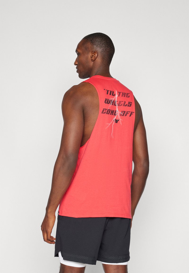 Red sleeveless tank top with a round neck featuring black text on the back. Worn with black shorts, showcasing a sporty design.