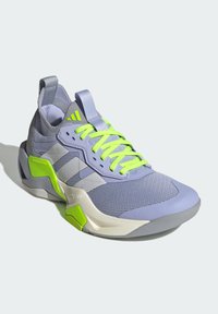 Purple athletic shoe with neon green laces and accents, mesh upper, textured sole, distinct geometric design, and a padded collar.