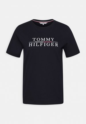 Navy blue cotton t-shirt with short sleeves and crew neck. Features a white logo with "TOMMY HILFIGER" on the front, accented by red lines.