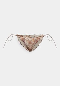 Bas de bikini à motifs brun et crème avec un bord festonné et des lanières sur les côtés, présentant un design à imprimé ressemblant à celui d'une girafe.
