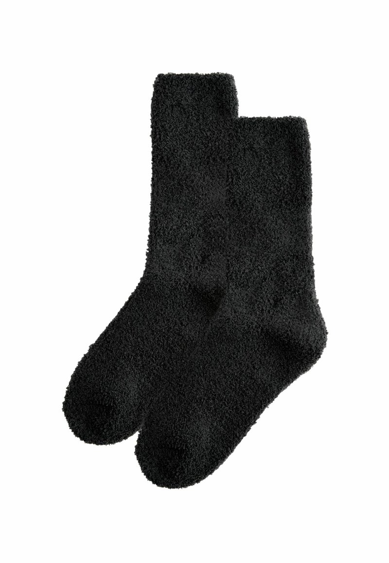 Black, fuzzy socks with a soft texture, featuring a classic shape and ribbed ankle. Designed for comfort and warmth.