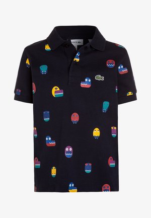 Kurzarm-Polohemd aus nachtblauem Baumwollstoff, mit bunten Monster-Grafiken, einer Knopfleiste mit drei Knöpfen und einem grünen Logoakzent auf der Brust.
