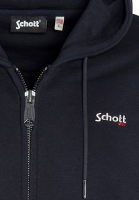 Giacca zip con cappuccio navy in tessuto a coste, con zip argentata e logo ricamato "Schott NYC" in bianco e rosso sul petto. Etichetta di taglia L inclusa.