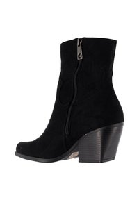 Stivaletto alla caviglia in camoscio nero con cerniera laterale, caratterizzato da una punta arrotondata e un tacco medio a blocco. Texture liscia e dettagli di design minimalisti.